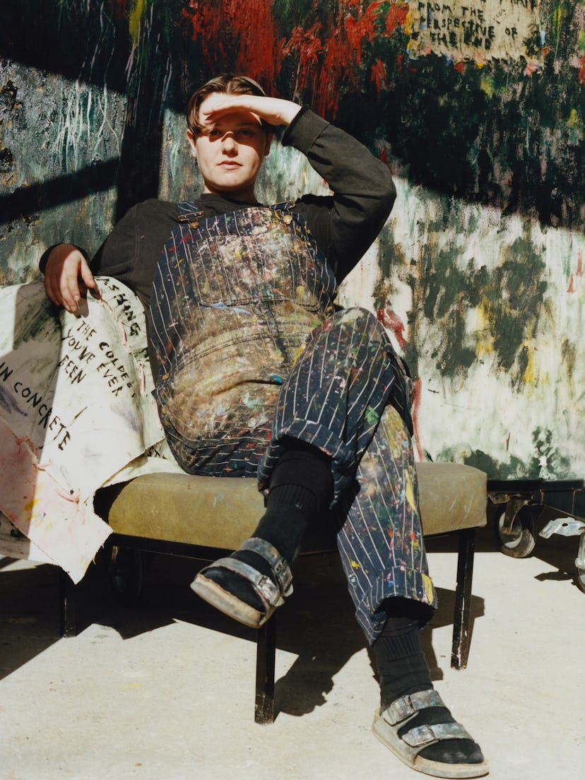 Daisy Parris sitting in their studio