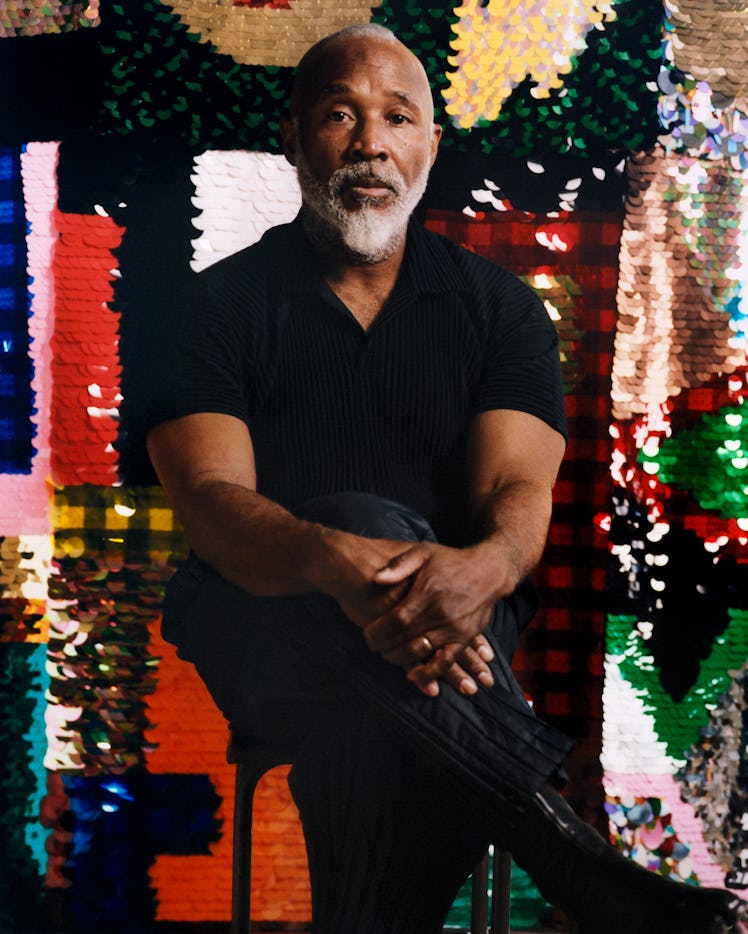 Artist Nick Cave sitting in a chair