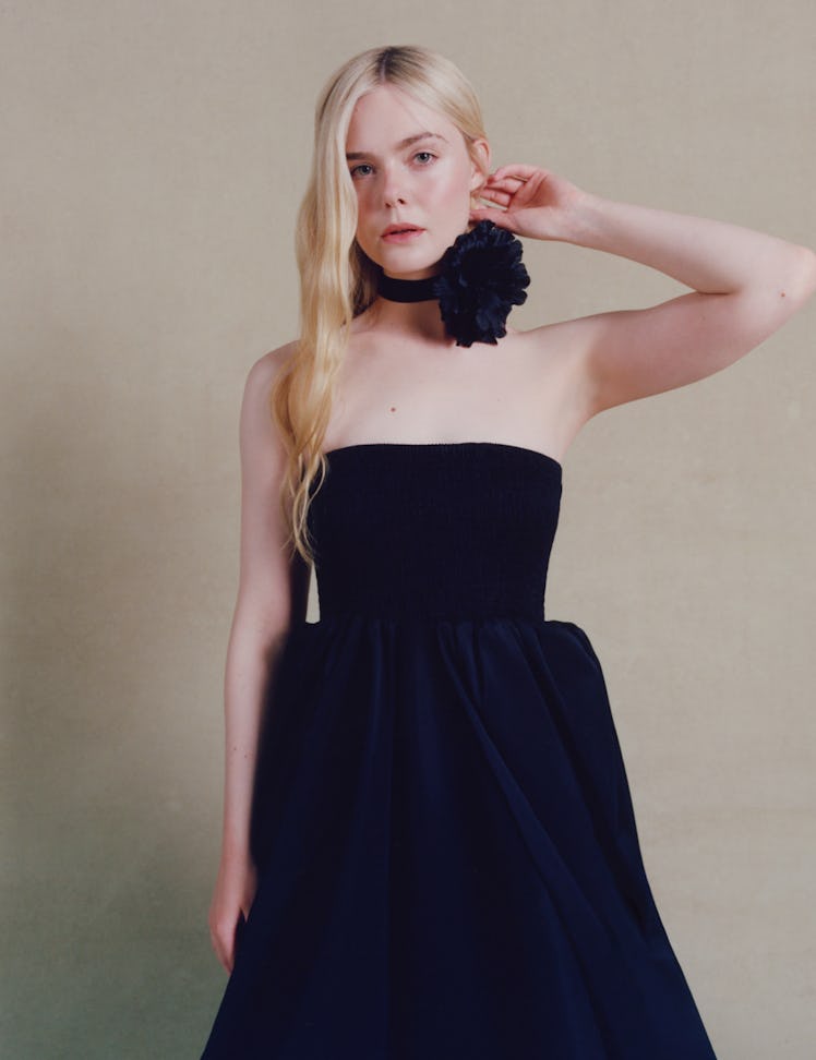 Fanning wears a Christopher John Rogers jumpsuit and neck piece.