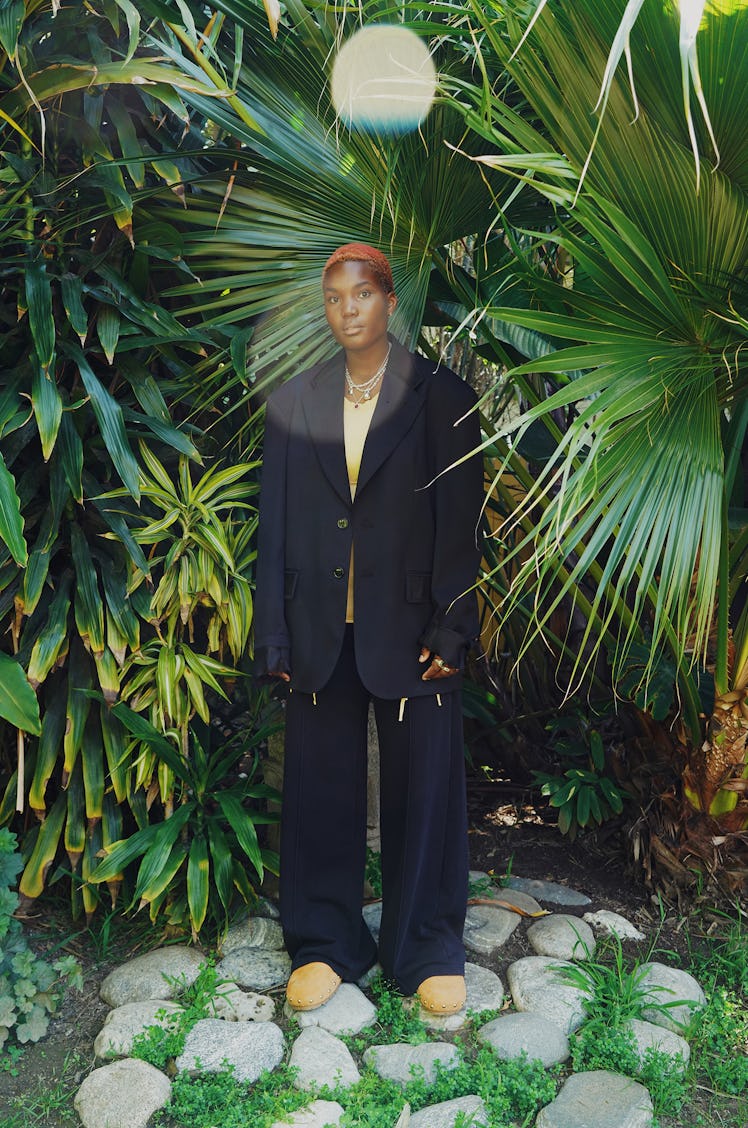 Arlo Parks wears an MM6 Maison Margiela jacket and sweatpants; Jacquemus top and shoes; Tiffany & Co...