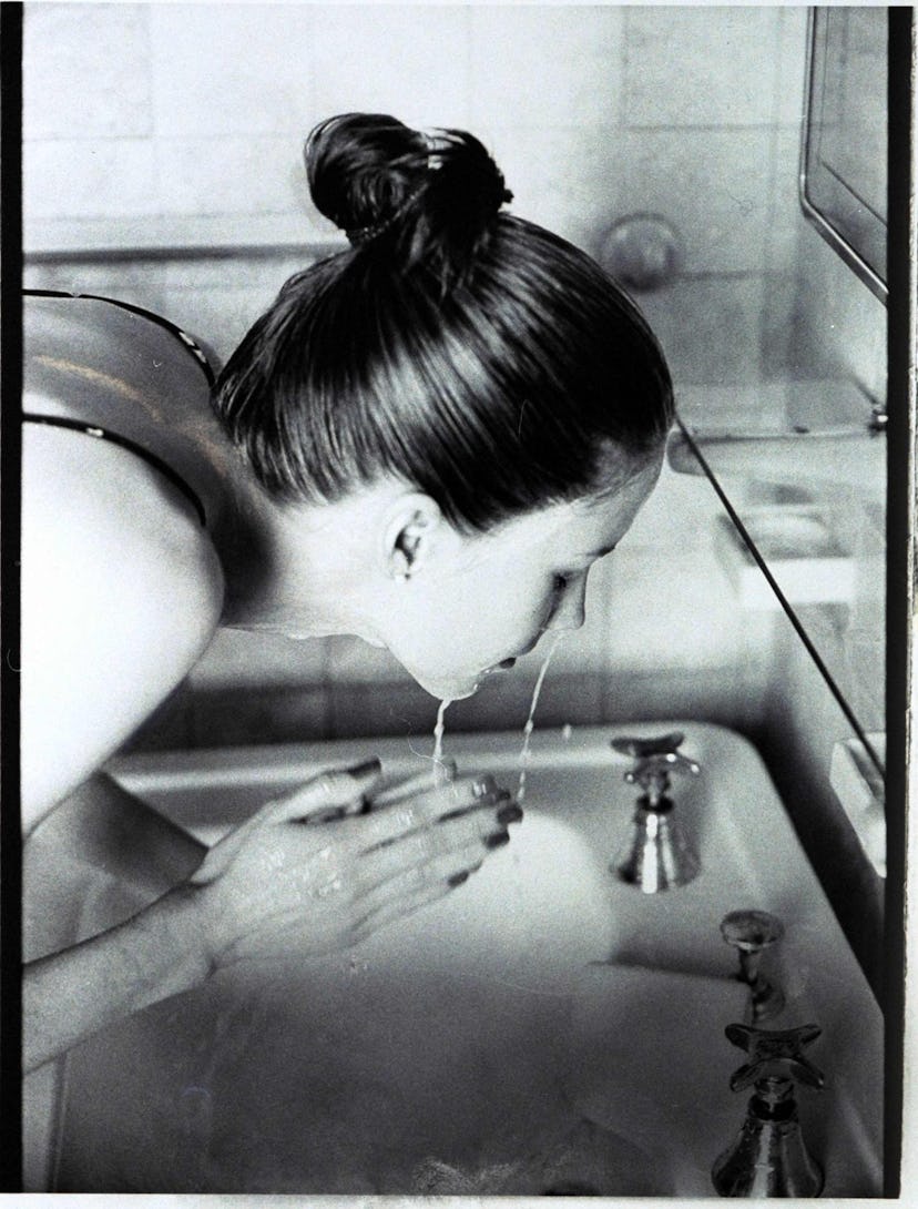 A woman washing her face with clean beauty formulation skincare products