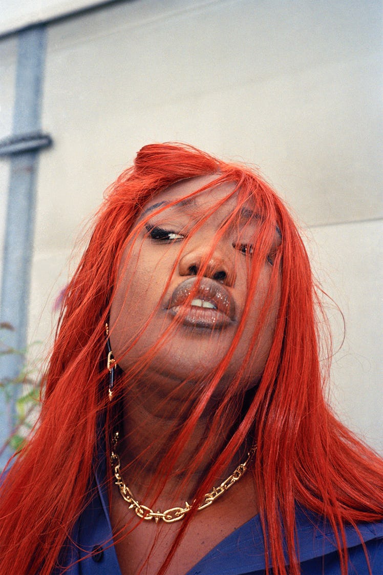 Christelle Oyiri wears a Balenciaga shirt; Tiffany & Co. Tiffany Titan by Pharrell Williams earrings...